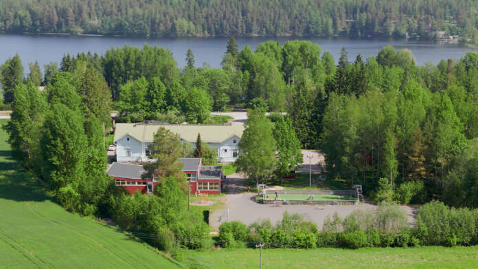 Mainosvideossa on myös kuvia lintuperspektiivistä. Tässä Oinasjärven koulu ja takana siintää Oinasjärvi.
